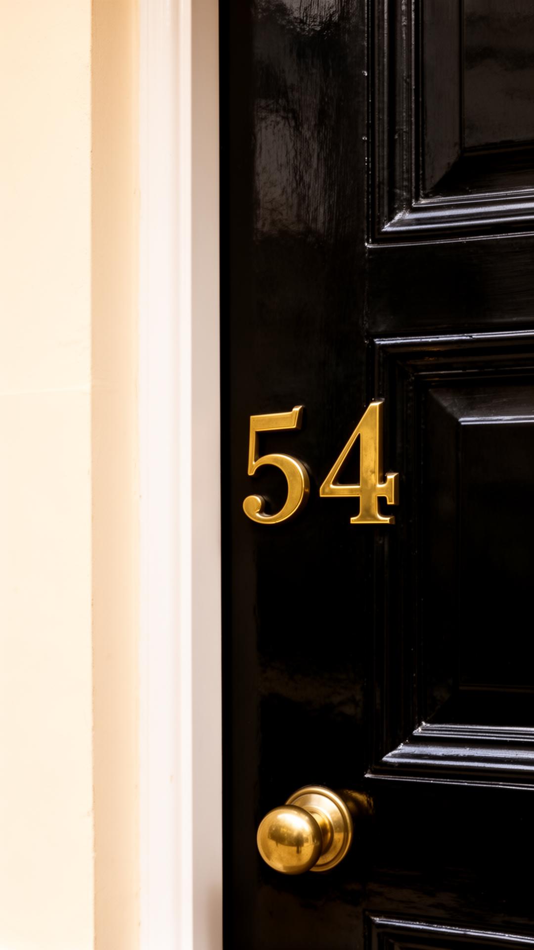 Polished brass numerals on a Mayfair door